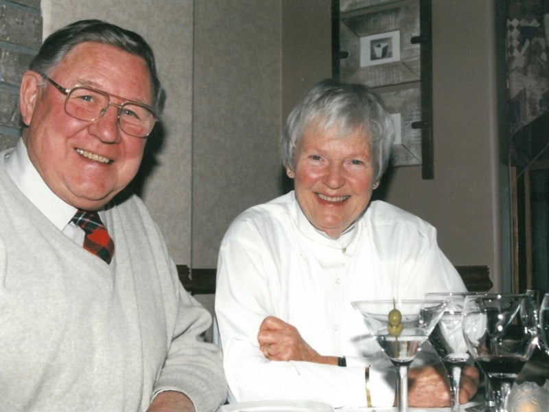 beaming couple looking to the camera at their fiftieth wedding anniversary.