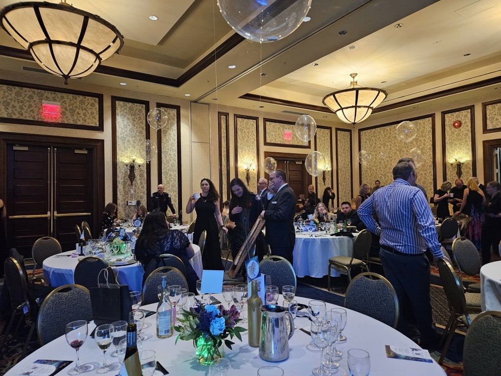 folks mingle among the tables in the ballroom at the Sun Peaks Volunteer Fire Department Society’s Gala.